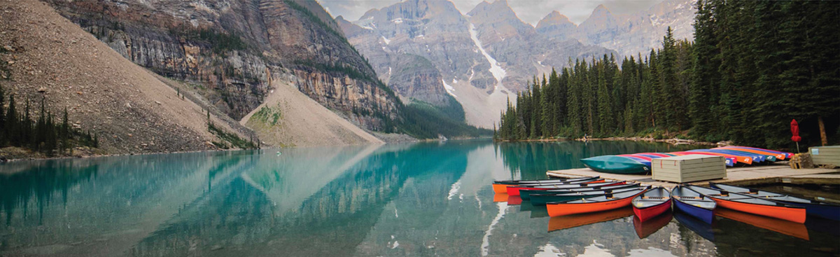 Cover showing mountains, canoes and lake