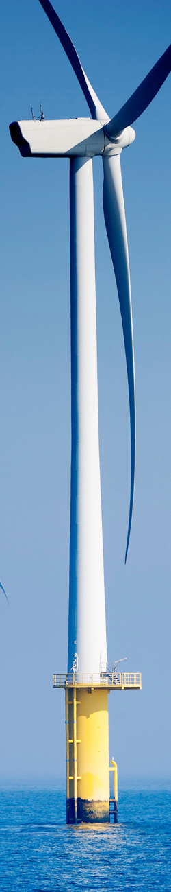Vertical photo of an offshore wind turbine in the ocean