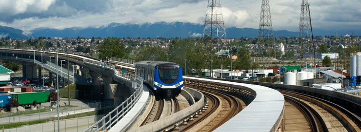 The Sky Train in Vancouver crossing a bridge over an industrial park